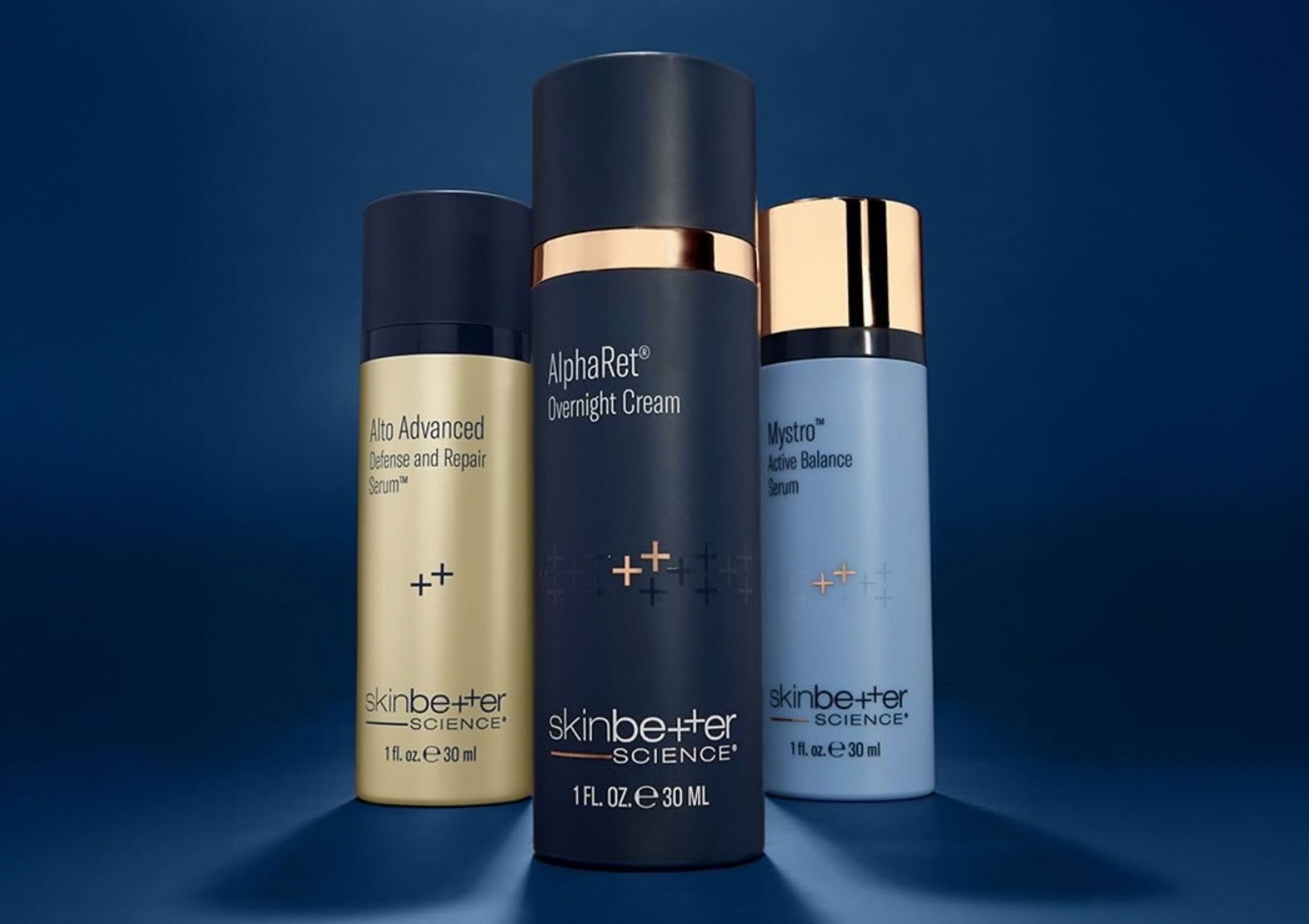 Three SkinCeuticals serum bottles with dropper tops in orange, clear, and purple liquids, displayed against a gray gradient background.